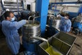 Palestinians work in a factory to extract olive oil during the annual harvest season