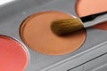 Palette of brown and terracotta eye shadow and makeup brush Royalty Free Stock Photo