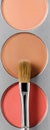 Palette of brown and terracotta eye shadow and makeup brush, top view Royalty Free Stock Photo