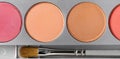 Palette of brown and terracotta eye shadow and makeup brush, top view Royalty Free Stock Photo