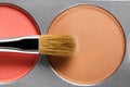 Palette of brown and terracotta eye shadow and makeup brush, top view Royalty Free Stock Photo