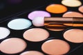 Palette concealer and correctors. Make-up base on black background Royalty Free Stock Photo