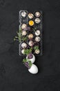 Palette with fresh quail eggs and watercress on a black background Royalty Free Stock Photo