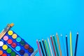 Palette with Rows of Multicolored Watercolor Paints Brushes Pencils on Blue Background. Arts School Class Creativity Painting Royalty Free Stock Photo