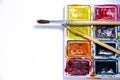 Palette with watercolors and brushes for paints on a white background Royalty Free Stock Photo