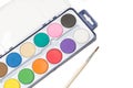 A palette of watercolors and a painthbrush on a white background Royalty Free Stock Photo