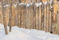 Paling, Wooden fence made of logs in the village, winter Royalty Free Stock Photo