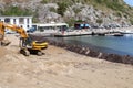Palinuro - Escavatore sulla spiaggia del porto