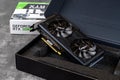 Palit Nvidia Geforce RTX 3060 Ti Dual OC gaming graphics card in an open box against dark background. Modern desktop pc hardware