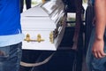 Pallbearers carefully oversee the process of lowering the casket to the ground for the deceased to its final place of rest Royalty Free Stock Photo