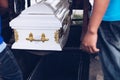 Pallbearers carefully oversee the process of lowering the casket to the ground for the deceased to its final place of rest Royalty Free Stock Photo