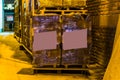 Pallet with blank labels in front of a big row of stacked pallets, pallet filled with stone pavements, Construction industry and