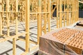 Pallet of bricks next to house construction site