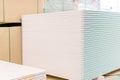 Pallet with Drywall sheets plasterboard in the building warehouse store. Stacking of white gypsum panels, drywall or plasterboard Royalty Free Stock Photo