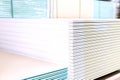 Pallet with Drywall sheets plasterboard in the building warehouse store. Stacking of white gypsum panels, drywall or plasterboard Royalty Free Stock Photo