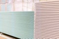 Pallet with Drywall sheets plasterboard in the building warehouse store. Stacking of white gypsum panels, drywall or plasterboard Royalty Free Stock Photo