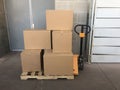 Pallet jack with cardboard box from delivery to warehouse Royalty Free Stock Photo