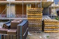 Pallet of roof tiling with jetty and empty pallets in background, construction site in Rucphen, The Netherlands, 6 may, 2022