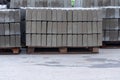Pallet With A Stack Of Concrete Curb stone on construction site. Road repairs. Few stacks of curbs prepared for laying Royalty Free Stock Photo