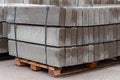 Pallet With A Stack Of Concrete Curb stone on construction site. Road repairs. Few stacks of curbs prepared for laying Royalty Free Stock Photo