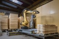 palletizing robot loading heavy objects onto pallets with motorized gripper