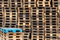 Pallets background. Stacks of old rough wooden pallets at warehouse in industrial yard. Cargo and shipping concept Royalty Free Stock Photo