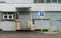 Pallets, used containers, boxes in front of the door of the warehouse or store