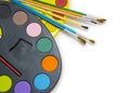 Pallette with brushes on a white background Royalty Free Stock Photo
