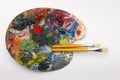 Pallette with brushes on a white background Royalty Free Stock Photo