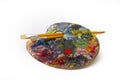 Pallette with brushes on a white background Royalty Free Stock Photo