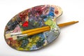 Pallette with brushes on a white background Royalty Free Stock Photo