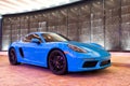 Palm Beach, Florida USA - March 22, 2021: bright blue Porsche 718 Cayman. corner side view.