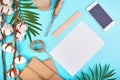 Palm branch, gift boxes, cotton balls, smartphone and jute rope hank on a blue background, Summer style. Free space for