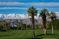 Palm Desert Desert Springs golf course mountains snow capped Palm trees Royalty Free Stock Photo