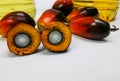 Palm fruits and palm oil, one fruit is cut to show its kernel Royalty Free Stock Photo