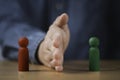 Palm hand blocking and divide between red and green wooden figure for resolving conflict and mediate management concept