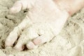 The palm of a hand covered with sand Royalty Free Stock Photo