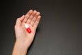 the palm of the hand gives help pill capsule for pain stress pain reliever red and white two halves antibiotic wishes health wants
