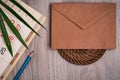 Palm leaf, calendar, pencil and envelope from old paper on a wooden table texture Royalty Free Stock Photo