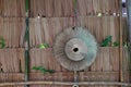 Palm leaf hat hanging on the thatch wall, the weave hat for Thai