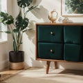 Palm leaf on a modern, teal sideboard with drawers in a luxurious, green living room interior with golden decorations and an uphol