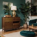 Palm leaf on a modern, teal sideboard with drawers in a luxurious, green living room interior with golden decorations and an uphol