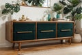 Palm leaf on a modern, teal sideboard with drawers in a luxurious, green living room interior with golden decorations and an uphol