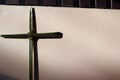 Palm leaf set cross to crucifix on the wall with the sunshine and shadow. Royalty Free Stock Photo