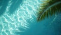 Palm leaf shadow on clear turquoise pool water surface ripples. Bright sunlight creates abstract pattern, calm blue liquid Royalty Free Stock Photo