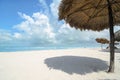 Palm Leaves shadow umbrellas at white sandy beach