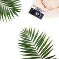 Flat lay travel concept - photo camera and palm leaf