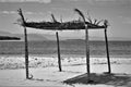 Palm leaves thatched shed with four pillars in an ocean