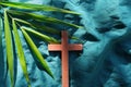 Palm leaves with wooden crucifix cross flat lay. Palm sunday celebration background. Royalty Free Stock Photo