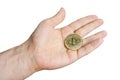 in the palm of a man is a gold cryptocoin Bitcoin